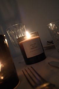 Kaboompics - Burning Amber Candle Beside Crystal Glassware