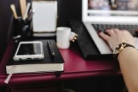 Kaboompics - Woman Working on MacBook with Phone, Notebook and Coffee
