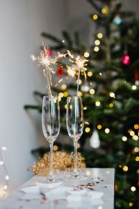 Kaboompics - Empty Champagne Glasses with Christmas Tree Bokeh and Gold Garland