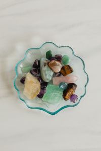 Kaboompics - Tumbled Crystal Collection in a Scalloped Glass Dish with White Copy Space