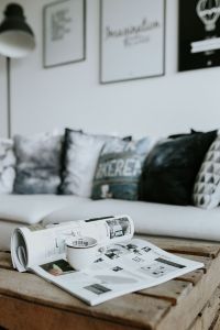 Kaboompics - Modern Living Room with Graphic Wall Art, Black-and-White Sofa Cushions and Coffee Table Magazines