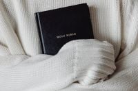 Kaboompics - Black Holy Bible Tucked into White Knitwear
