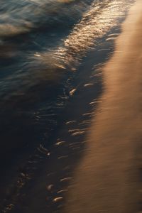Kaboompics - Dark Beach Shore Texture with Golden Sunset Reflection
