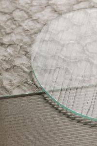 Kaboompics - Translucent Curved Glass Sheet over Ribbed Gray Texture