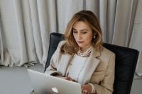 Kaboompics - Close-Up of Businesswoman Working on a Laptop in a Beige Blazer
