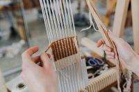 Kaboompics - Hands Working with White Threads at a Loom