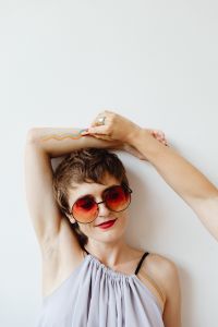 Kaboompics - Smiling Woman Raising an Arm with Rainbow Body Paint