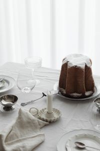 Kaboompics - White Christmas Dinner Table with Panettone, Candle and Neutral Place Setting
