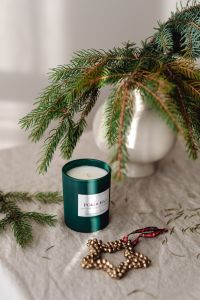 Kaboompics - Green Candle with Evergreen Branch and Christmas Beads