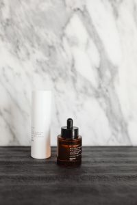 Kaboompics - Skincare Bottles on Dark Textured Surface