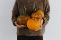 Kaboompics - Woman Holding Assorted Pumpkins in Brown Sweater