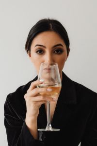 Kaboompics - Portrait of an Asian Woman Holding a White Wine Glass