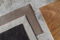 Kaboompics - Black and Taupe Bouclé Upholstery Fabric Swatches with Wood Sample