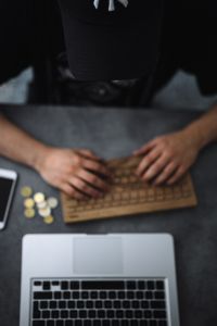 Kaboompics - Young man typing on the wooden keyboard