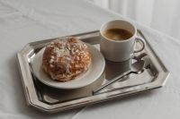 Kaboompics - Glazed Pastry and Coffee on Silver Tray over White Tablecloth