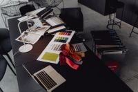 Kaboompics - Wide Interior Design Worktable with Sample Boards, Upholstery Swatches and Laptop