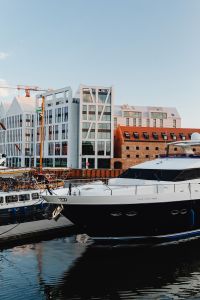 Kaboompics - Gdańsk Marina Yacht Foreground with Modern Waterfront Offices and Brick Warehouse