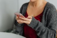 Kaboompics - A brunette woman works with a laptop and a phone