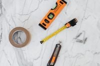 Kaboompics - Top-Down DIY Tool Flat Lay with Masking Tape, Utility Knife, Pencil and Wall Anchors