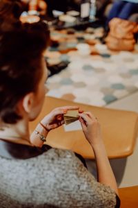 Kaboompics - Soft Focus Origami Workshop With People Around a Craft Table