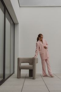 Kaboompics - Woman Standing in a Pale Pink Suit Beside a Chair