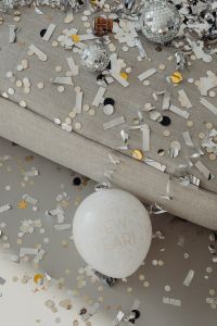 Kaboompics - New Year Greeting Balloon Framed by Silver Confetti and Party Streamers