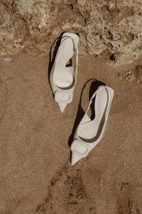 Kaboompics - White Buckle Pumps with Crisp Shadows on Beach Sand