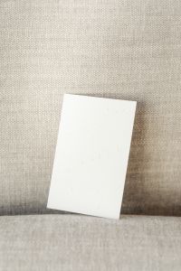 Kaboompics - Large Portrait Business Card Mockup on Coarse Beige Fabric