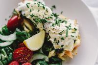 Kaboompics - Close up image of young woman eating classic breakfast at restaurant