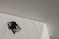 Kaboompics - Dollar Bills Tied With Red Bow on White Fabric