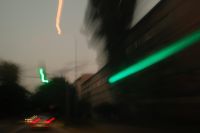 Kaboompics - Green Light Trail beside a Blurred Tree-Lined City Road