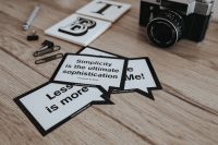 Kaboompics - Little cards with inspirational quotes and a black camera
