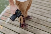 Kaboompics - Photographer holding a DSLR camera