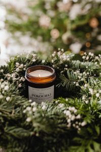 Kaboompics - Close Up of Amber Candle Jar in Christmas Greenery
