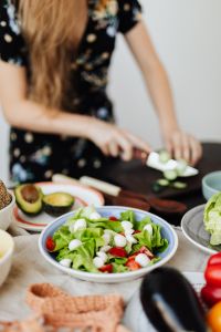 Kaboompics - Fresh Green Salad with Mozzarella and Tomatoes beside Cucumber Prep