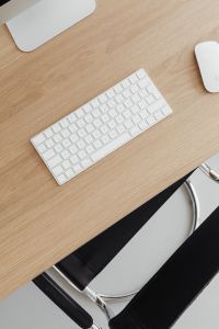Kaboompics - Oak Wood Desk Background with White Keyboard and Office Chair