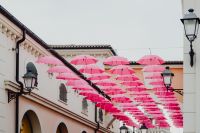 Kaboompics - Pink Umbrellas over Designer Outlet Shopping Street