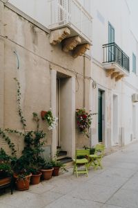 Kaboompics - Green Chairs Along a Quiet Old-Town Street in Sardinia