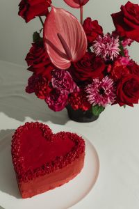 Kaboompics - Red Flower Bouquet and Heart-Shaped Cake on a White Table