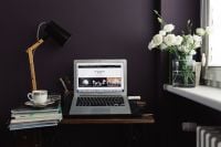 Kaboompics - Contemporary Dark Home Office with Laptop, Lamp and White Flowers