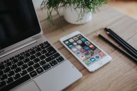 Kaboompics - Silver Acer laptop on a wooden desk with a green plant, pencils and an Apple iPhone