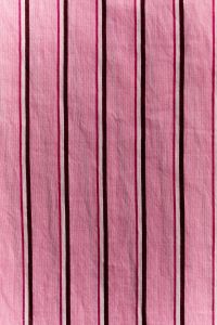 Kaboompics - Pink Multistripe Cotton Fabric Texture with Alternating Burgundy Lines, Vertical Textile Background for Fashion and Design
