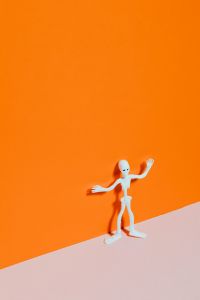 Kaboompics - White Skeleton Halloween Figure Standing on Orange and Pink Background
