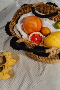 Kaboompics - Wicker Basket with Grapefruit and Citrus on a Beach Towel