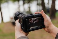 Kaboompics - Hands Holding Cinema Camera with Outdoor Preview on Screen