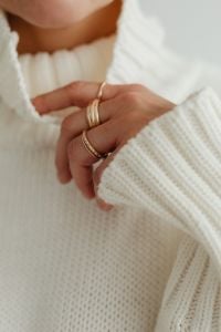 Kaboompics - Close-Up of Gold Rings on Hand in White Sweater