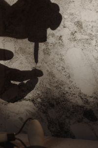 Kaboompics - Shadow of Hands Using a Skincare Dropper on a Marble Surface
