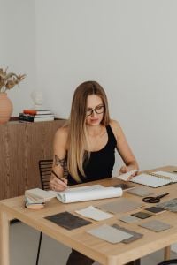 Kaboompics - Woman Working at Desk With Fabric Samples