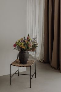 Kaboompics - Small Floral Arrangement Near White and Taupe Curtains
