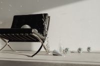 Kaboompics - Black Lounge Chair with Disco Balls and Party Cone Beside a Glass Vase